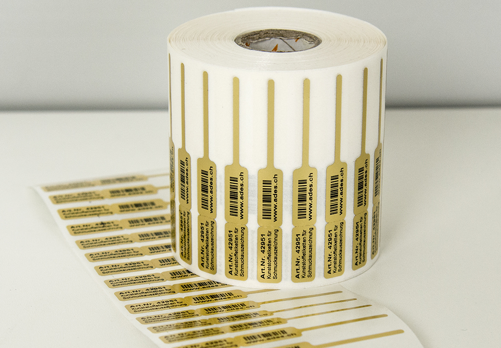 Goldige Schmuck-Rollenetiketten für die Beschriftung von Ringen, Halsketten, Armbändern, Ohrschmuck etc. Die Schmucketiketten können beidseitig individuell bedruckt werden.